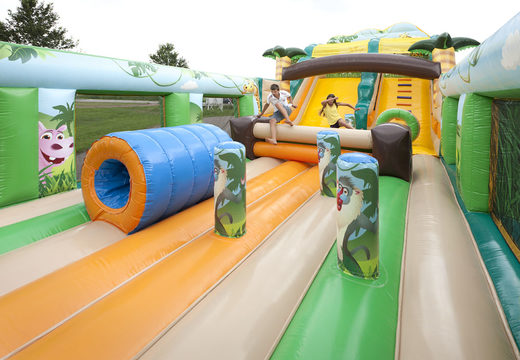 Buy a unique extra wide inflatable slide in the jungle world theme with 3D obstacles for children. Order inflatable slides now online at JB Inflatables UK
