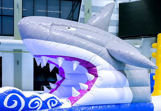 Spectacular inflatable shark run obstacle course in a unique design with funny 3D objects and no less than 2 slides for kids. Order inflatable water attractions now online at JB Inflatables UK
