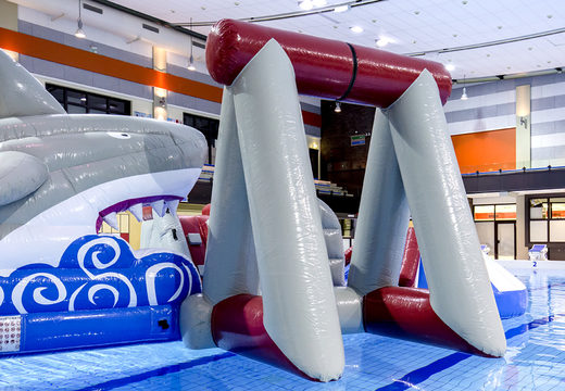 Unique airtight inflatable play island in shark theme with a liana, climbing tower, round slide and obstacles for both young and old. Buy inflatable water attractions online now at JB Inflatables UK