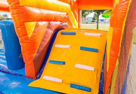 Inflatable covered bouncer in a pirate theme with a slide on the jumping surface, climbing tower and fun obstacles for kids. Buy bouncers online at JB Inflatables UK