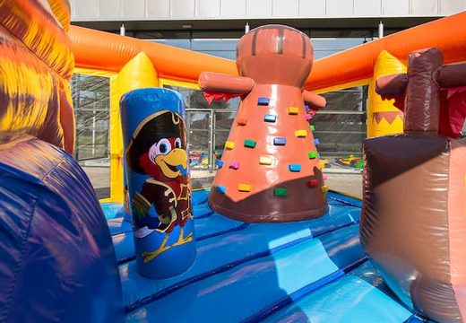 Pirate themed bouncy castle with a slide for children. Order bouncy castles online at JB Inflatables UK