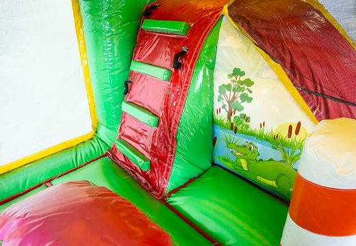 Inflatable multiplay Jungleworld bouncer with a slide in the middle and 3D objects for children. Order bouncers online at JB Inflatables UK