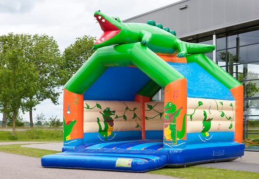 Super bouncy castle with roof in crocodile theme for kids. Buy bouncy castles online at JB Inflatables UK