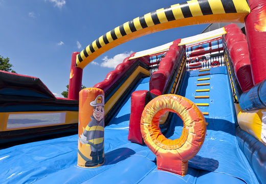 Buy a unique extra wide inflatable slide in the Fire Brigade World theme with 3D obstacles for children. Order inflatable slides now online at JB Inflatables UK