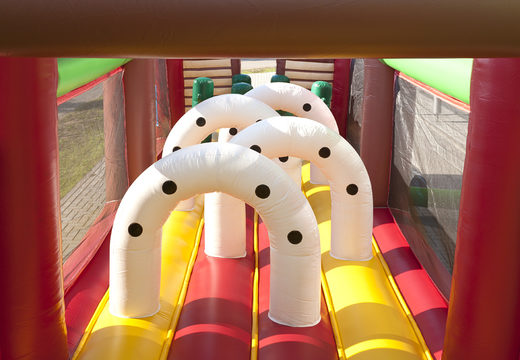 Unique 17 meter wide obstacle course in a cowboy theme with 7 game elements and colorful objects for kids. Buy inflatable obstacle courses online now at JB Inflatables UK