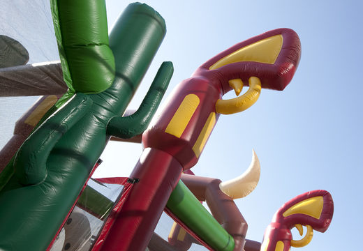 Buy a unique 17 meter wide cowboy themed obstacle course with 7 game elements and colorful objects for kids. Order inflatable obstacle courses now online at JB Inflatables UK