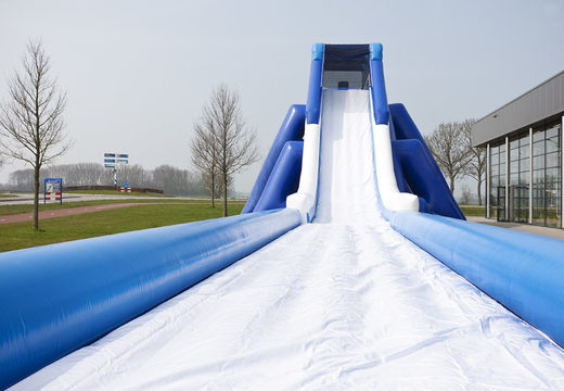Monster slide inflatable 11 meters high and 53 meters long with a double staircase. Order inflatable slides now online at JB Inflatables UK