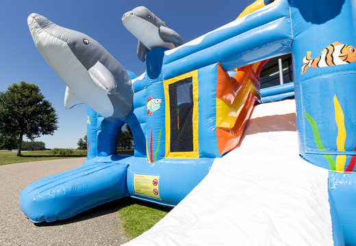 Medium inflatable multiplay bouncy castle in dolphin theme with slide for children. Order inflatable bouncy castles online at JB Inflatables UK