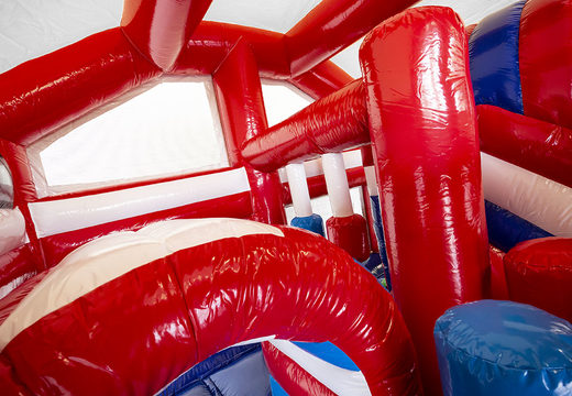 Medium inflatable bouncy castle in fire department theme with slide and pillars on the jumping surface, buy for children. Order inflatable bouncy castles online at JB Inflatables UK
