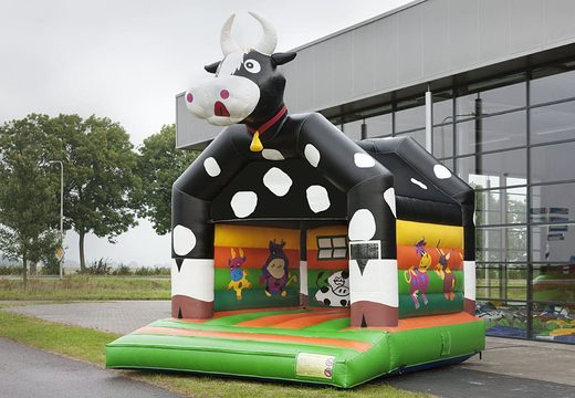 Buy a standard bouncy castle for children in striking colors with a large 3D object in the shape of a cow on top. Order bouncy castles online at JB Inflatables UK