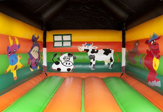 Order a standard bouncy castle for children in striking colors with a large 3D object of a cow on top. Bouncy castle for sale online at JB Inflatables UK