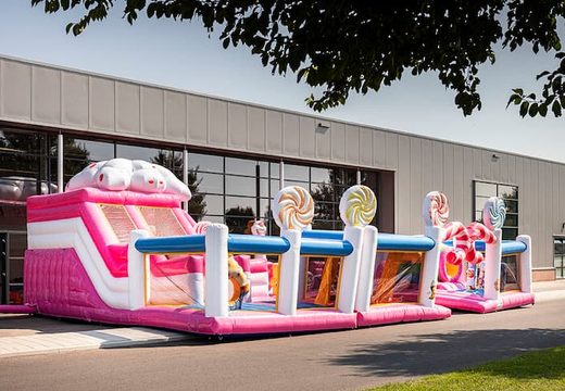 Candyworld themed inflatable bouncy castle with multiple slides and all sorts of fun obstacles with themed prints for kids. Order bouncy castles online at JB Inflatables UK