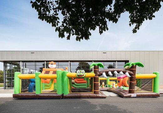 Jungle themed inflatable bouncy castle with multiple slides and all sorts of fun obstacles with themed prints for kids. Order bouncy castles online at JB Inflatables UK