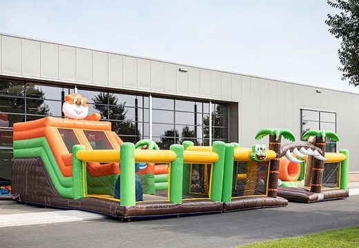 Bounce World jungle bouncy castle with multiple slides and all kinds of fun obstacles with jungle prints for children. Buy bouncy castles online at JB Inflatables UK