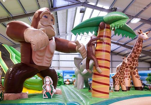 Giant inflatable bouncy castle with 8 slides, 2 climbing towers, inflatable 3D animals, fun obstacles and obstacle courses for children. Order bouncy castles online at JB Inflatables  UK