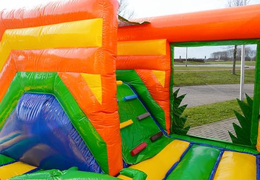 Order a large Indoor Jungle bouncer with a slide on the jumping surface, climbing tower and fun obstacles with jungle themed prints for kids. Buy bouncers online at JB Inflatables UK