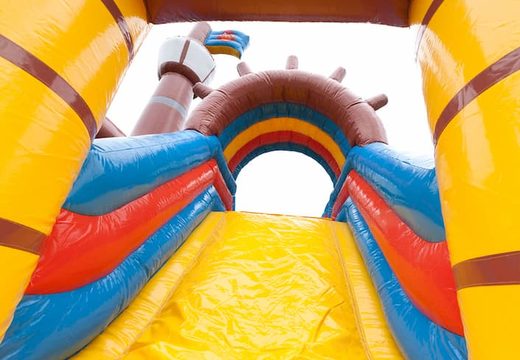 Buy pirate boat bounce house in a unique design with two entrances, a slide in the middle and 3D objects for kids. Order bounce houses online at JB Inflatables UK