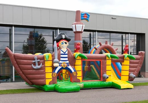 Multiplay XXL Pirate boat bouncy castle in a unique design with two entrances, a slide in the middle and 3D objects for children. Buy bouncy castles online at JB Inflatables UK