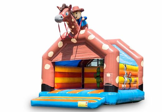 Big inflatable bounce house with roof in cowboy theme to buy for kids. Available at JB Inflatables UK online