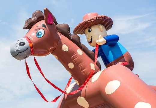 Buy a large indoor bouncy castle in a cowboy theme for kids. Order bouncy castles online at JB Inflatables UK 