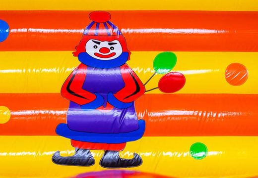 Clown with balloons on bouncy castle
